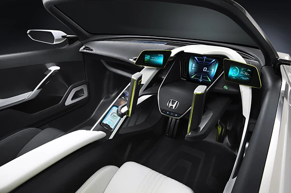 In the EV-STER's driving seat, with twin-lever controls and driver display