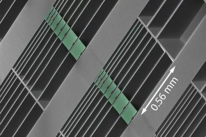 An array of the optomechanical accelerometers on the surface of a microchip – the proof masses are highlighted in green