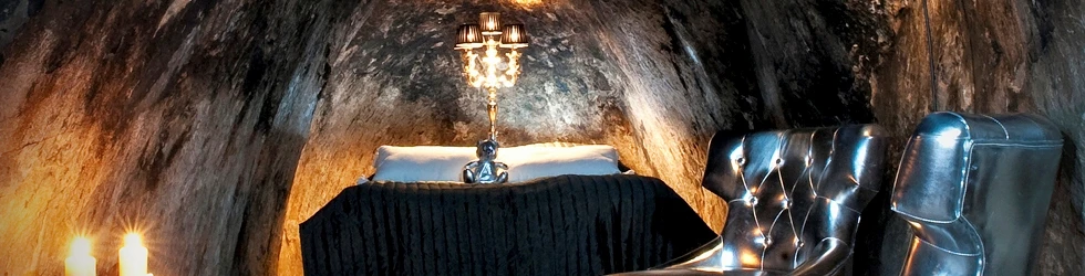 The suite is not suitable for claustrophobes, as the dark chamber features a double bed surrounded by three rock walls (image: Sala Silvermine)