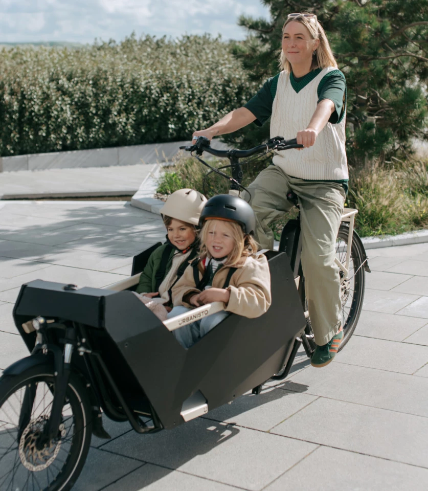Two small children are seated side-by-side in one of the two available cargo modules