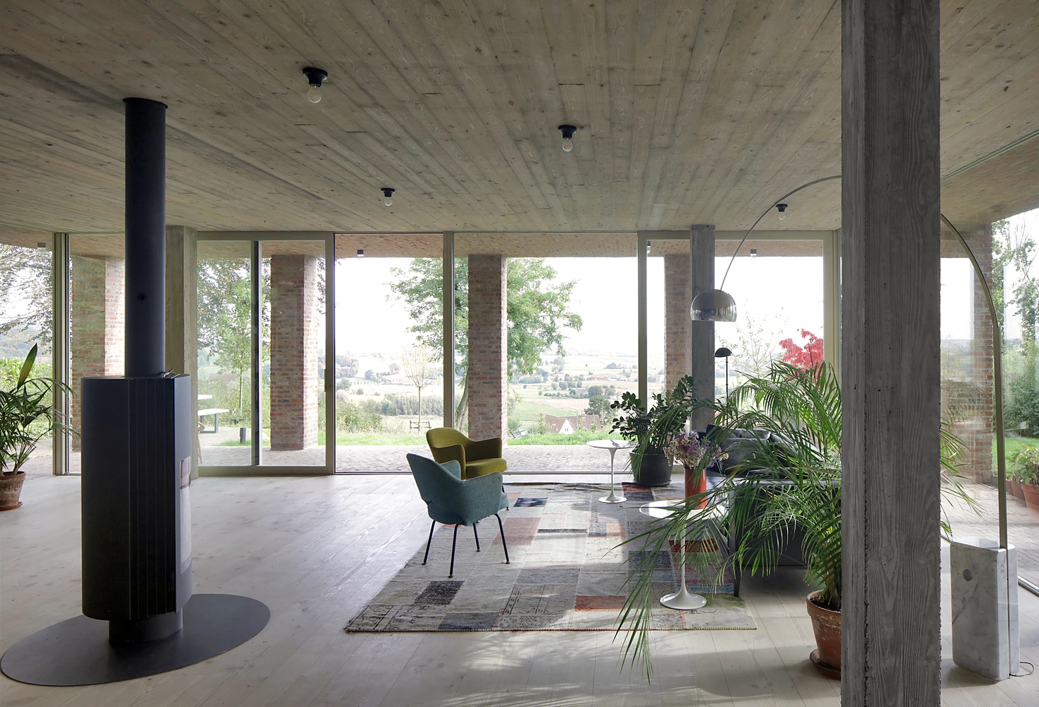 Sloped Villa features a simple interior with a collection of raw-concrete structural pillars