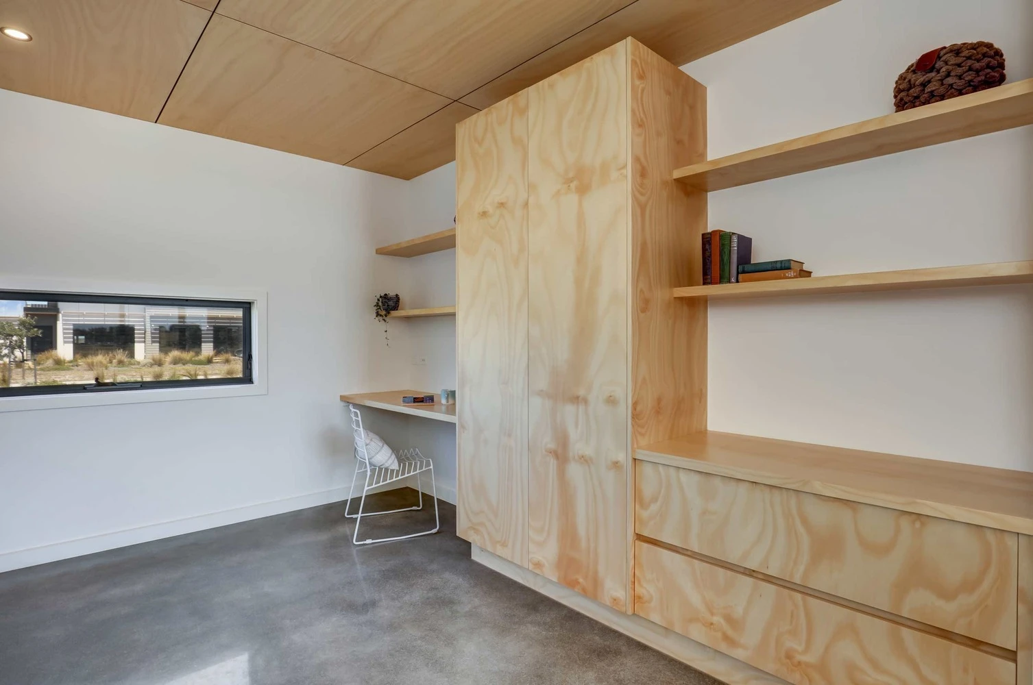 The interior of the home boasts polished concrete flooring and in-built timber furnishings