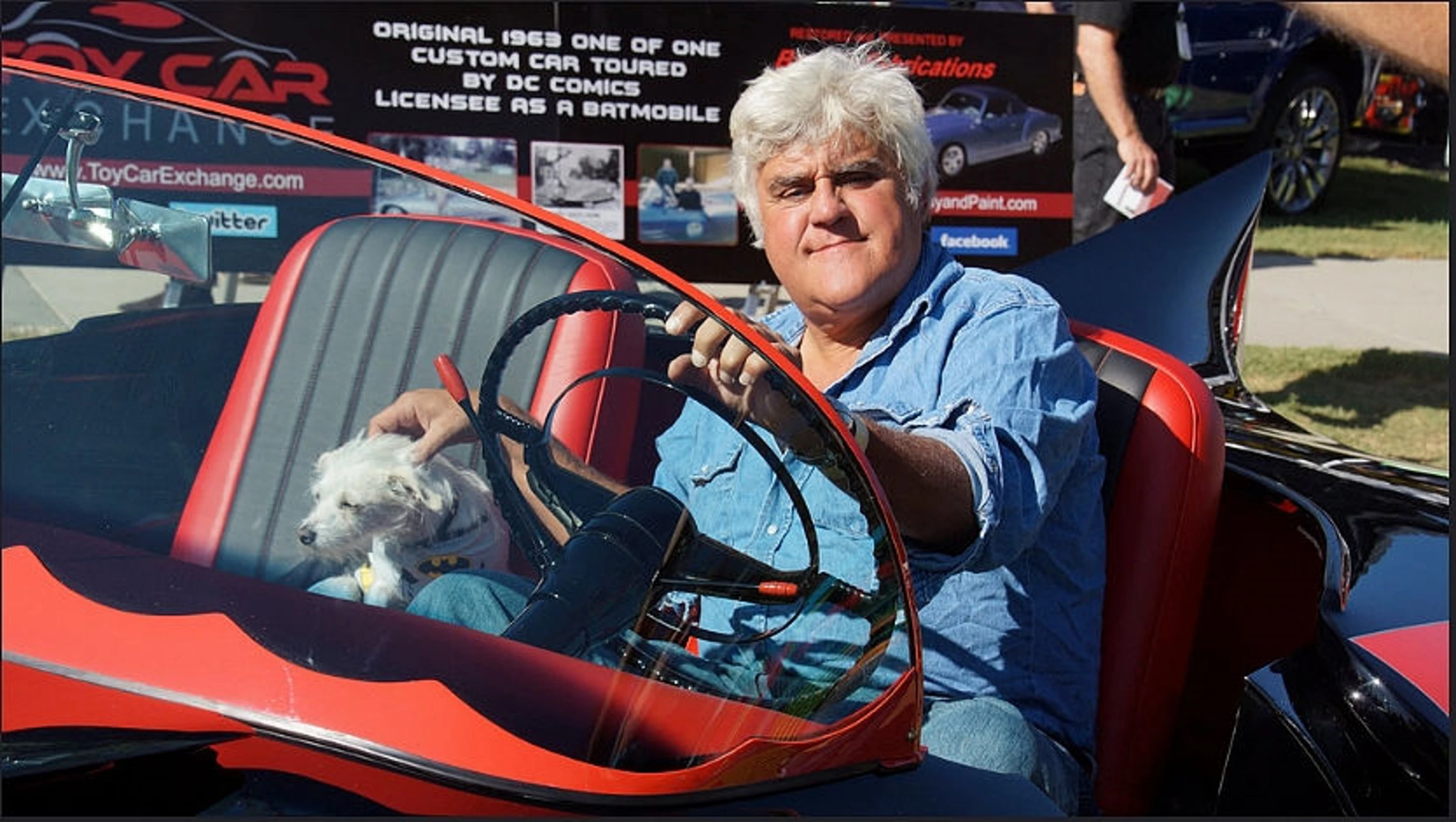 Comedian Jay Leno sitting in the 1963 Batmobile