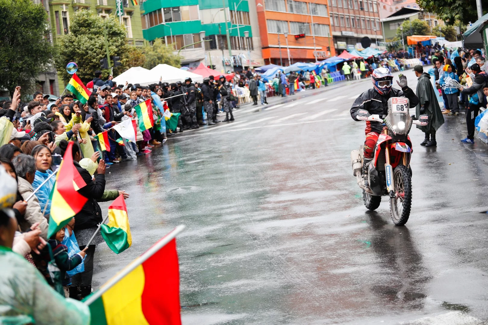 Peruvian Eduardo Heinrich waves to the crowd as he nears the end of 758 km of Stage 6