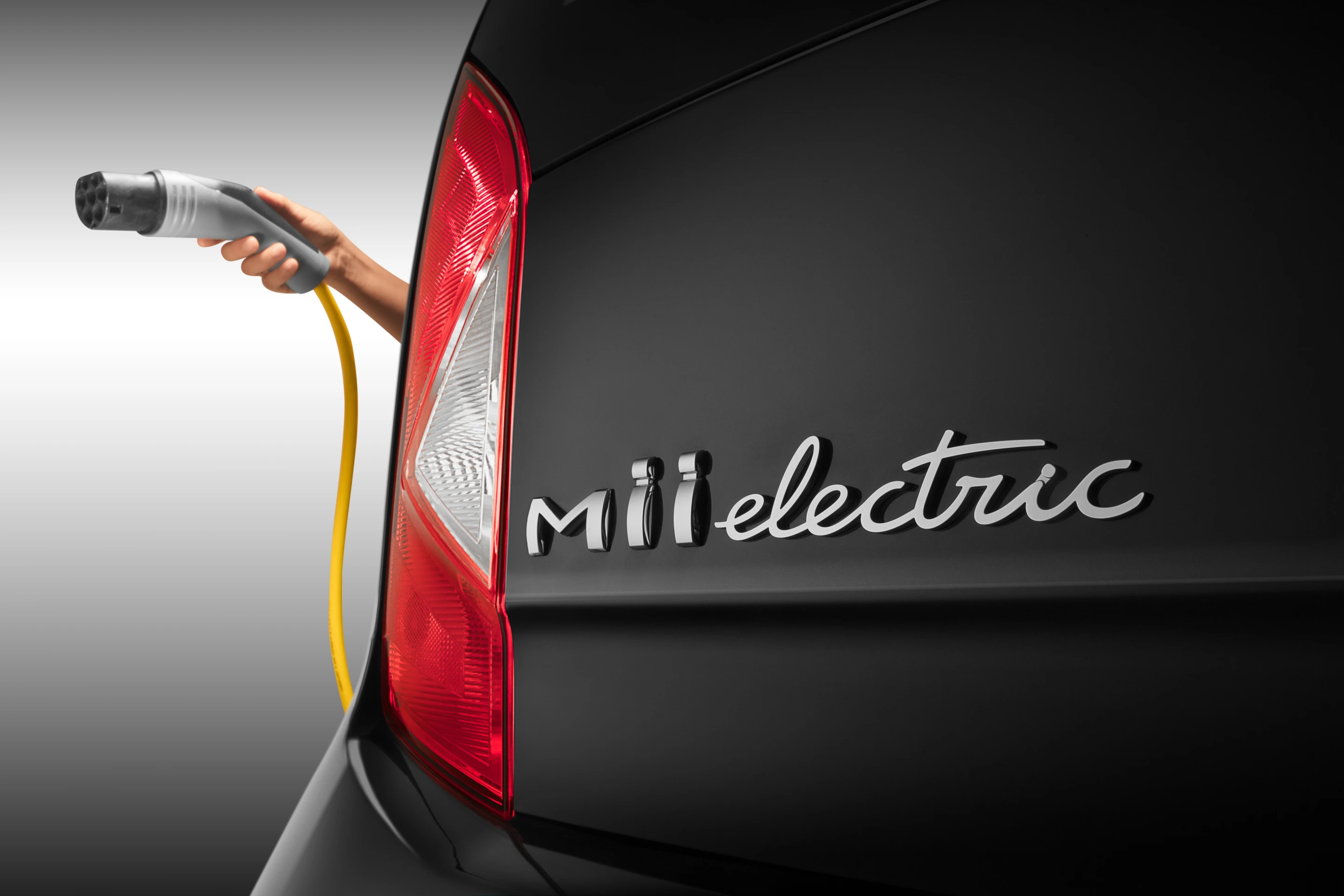 The outside of the vehicle is much the same as the ICE Mii before it, but with lettering and stickers identifying the car as electric