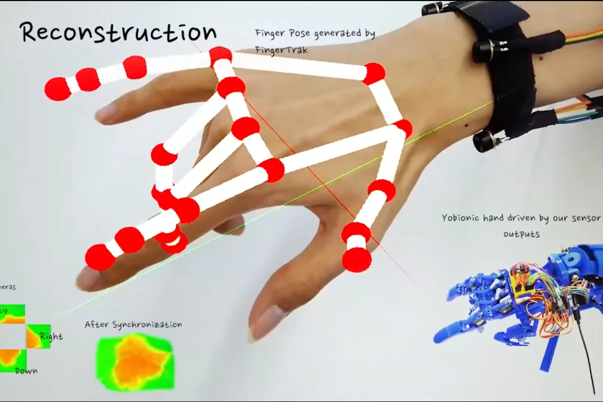 A digital model overlaid on a real hand, showing just how well the FingerTrak system can predict the positions of a wearer's fingers. At the bottom right, a robot hand copies the wearer