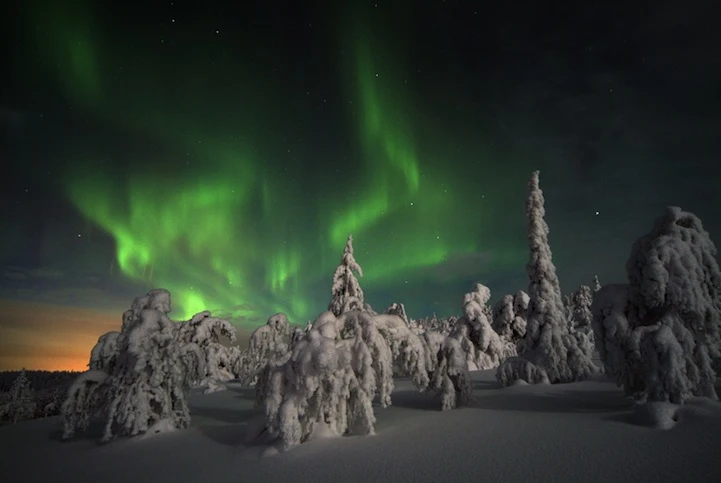 The night time light display of Aurora Borealis is caused by the collision of gaseous particles from the earth's atmosphere, with charged particles released from the sun's atmosphere (image from Hotel Kakslauttanen)