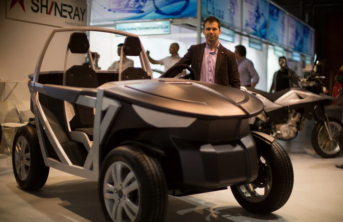 OSVehicle Project Chief Designer Marco Borge stands next to the Urban TABBY during EICMA Milan 2013