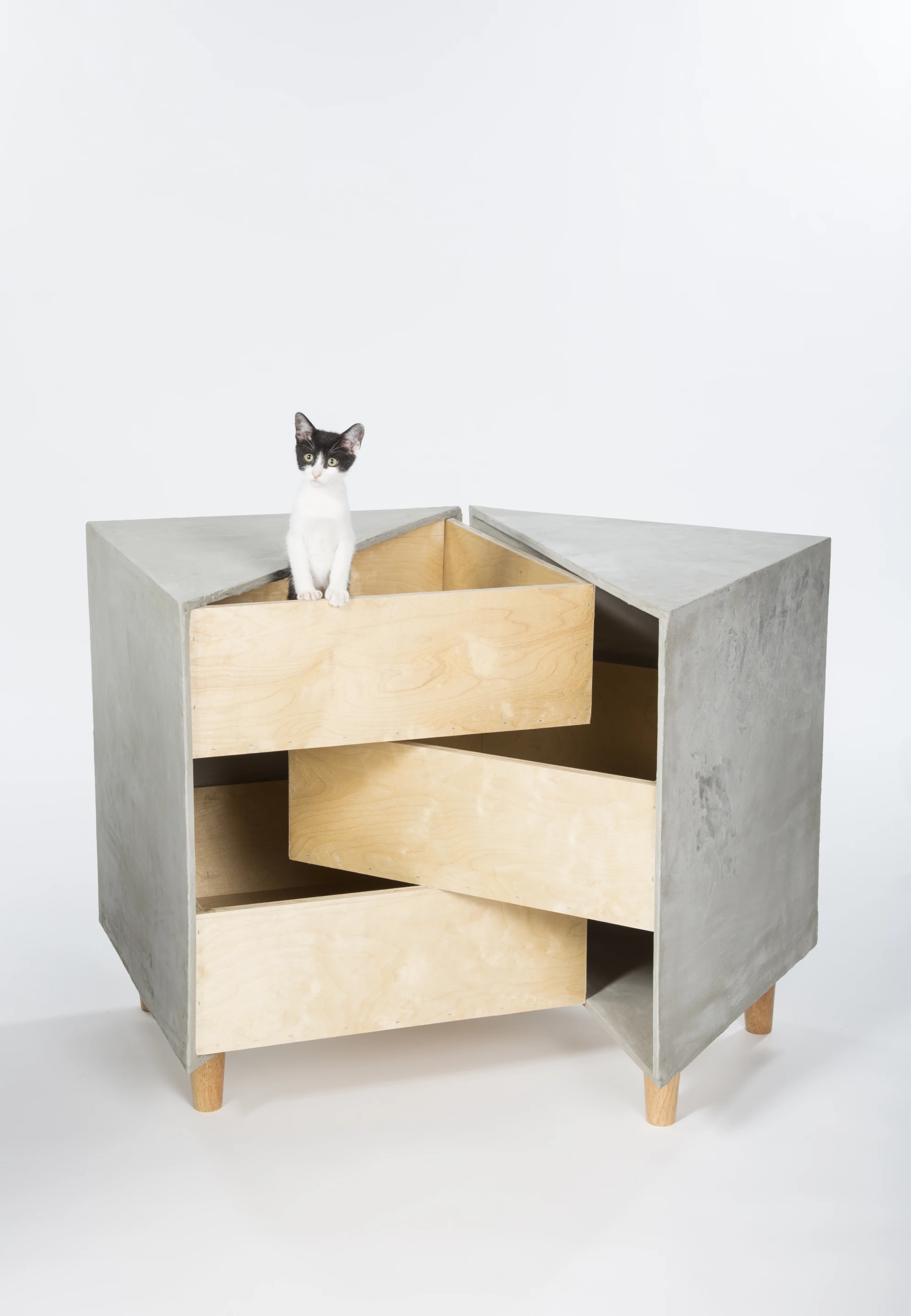 Sneaky Drawers, by rdc, is a shelter based on three intersecting drawers that provides a sanctuary for multiple cats