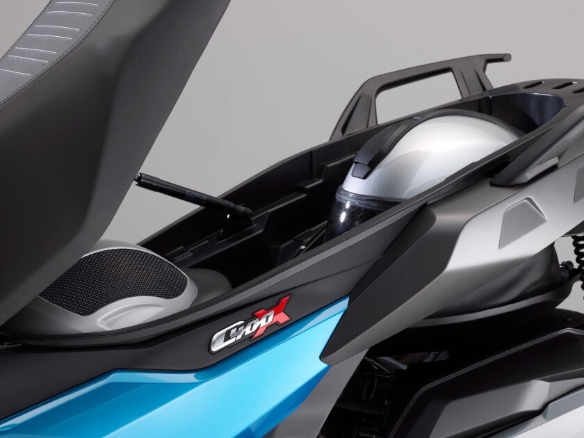BMW’s Flexcase (pictured) is a durable pouch that extends from the underside of the scooter, and allows you to fit a full-face helmet and an open-face helmet under the seat