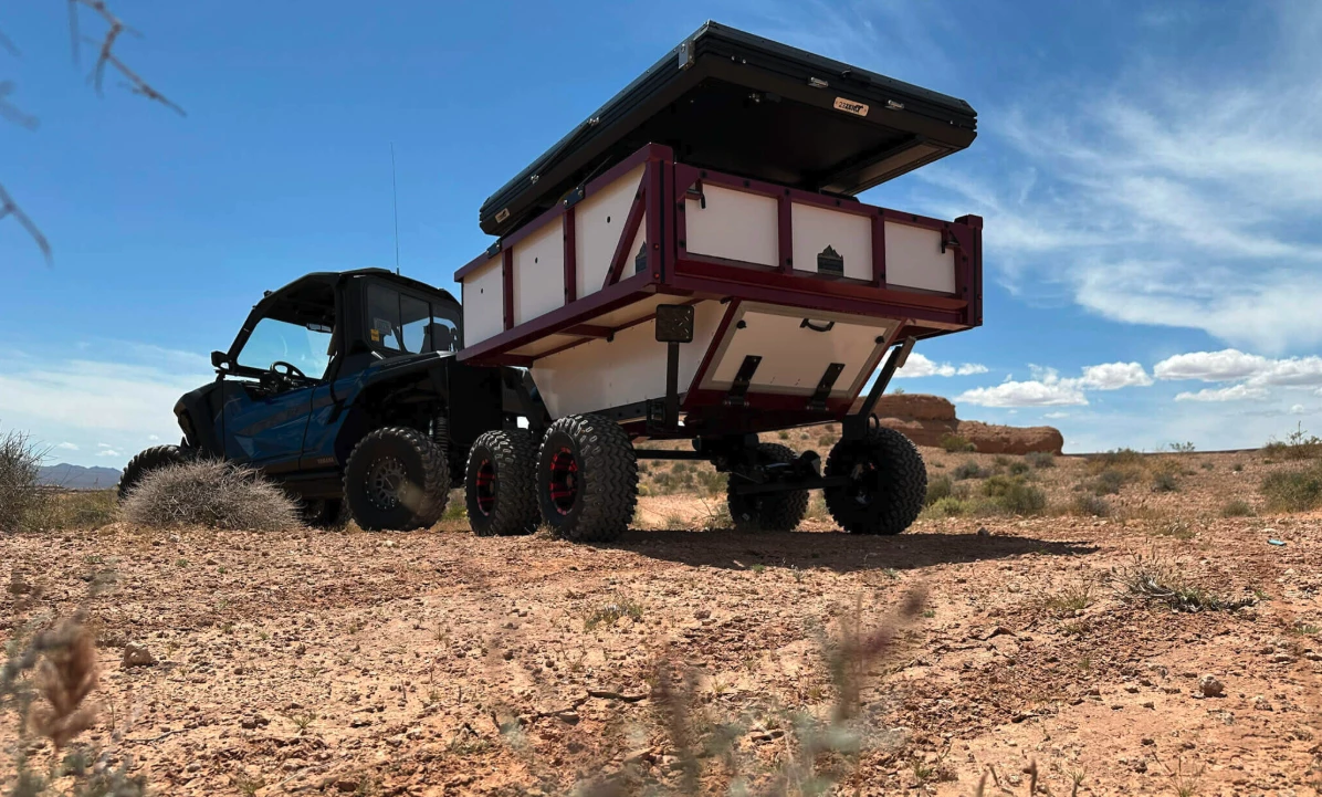 In place of your usual single- or dual-axle trailer suspension, Highcountry goes for the articulation of a Timbren walking beam setup; also note the lower drop-down hatch for the storage tub