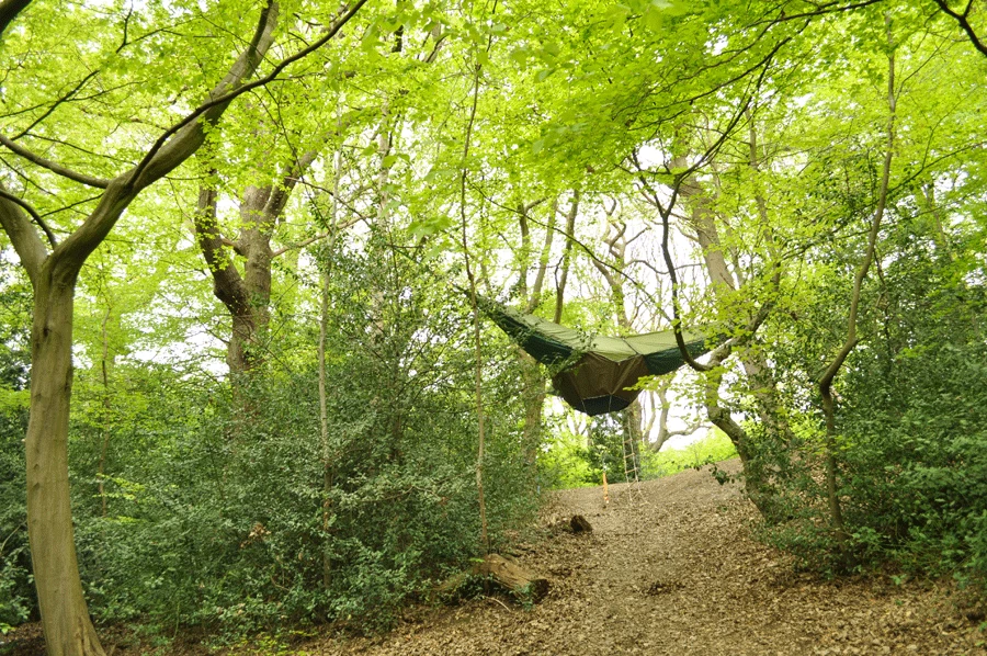 The ultra-portable shelter employs tension forces to provide a suspended habitat that is protected from wildlife