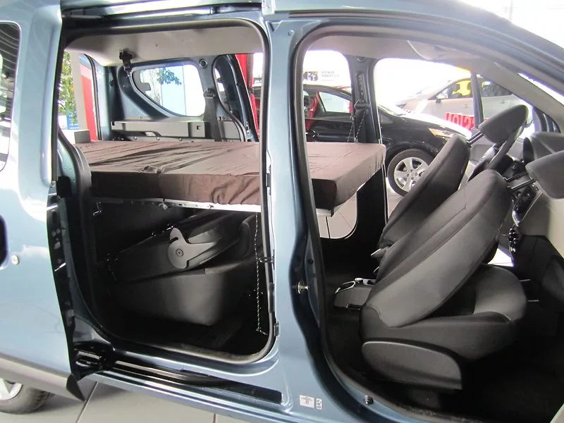 The three-piece bed folds out in seconds and straps to the seatbelt hardware for support