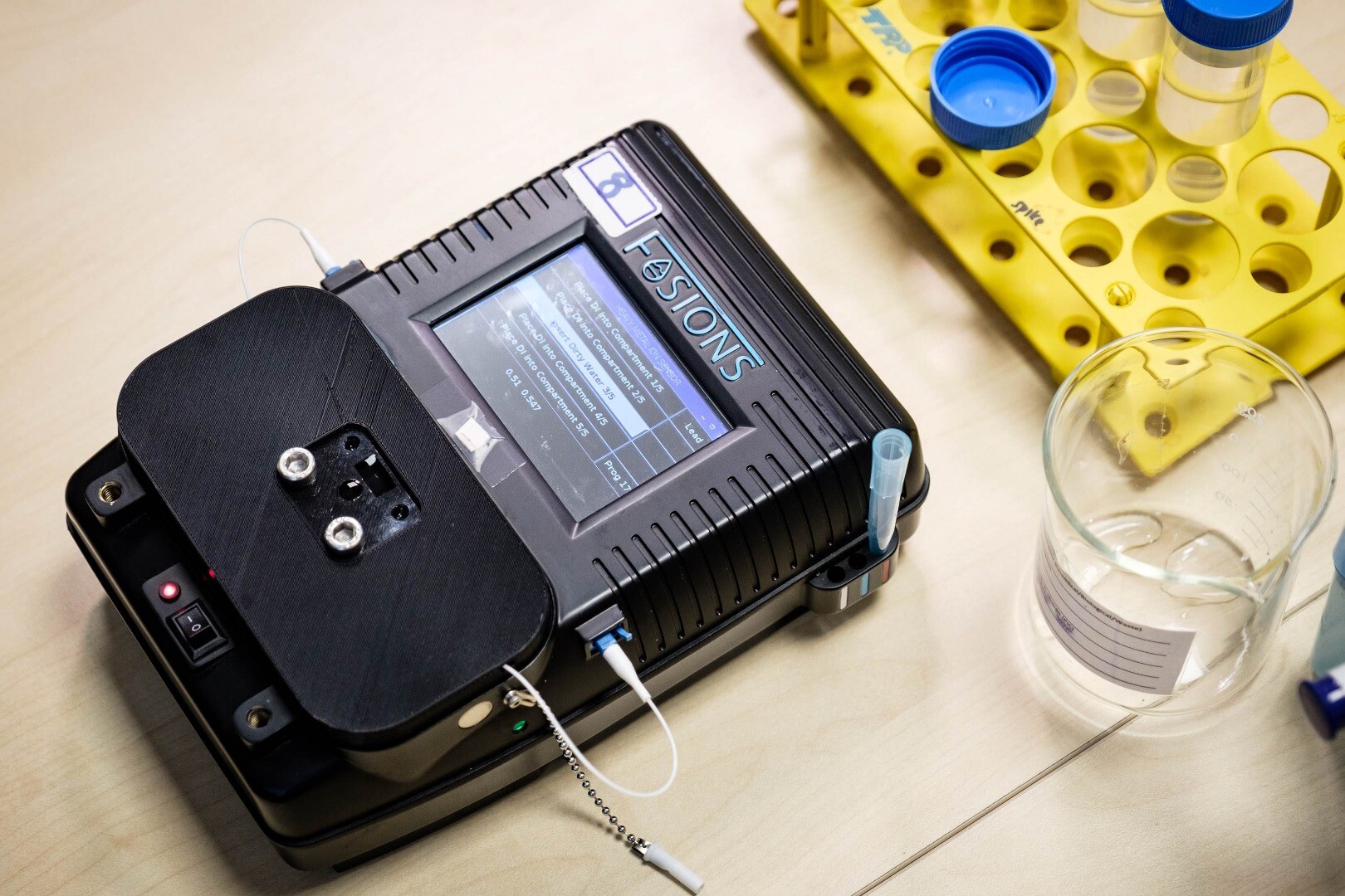 Portable watertesting device binds and shines