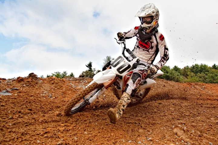 Cornering and kicking up dust on a Zero MX electric bike at the Dark Green track in Penrose, North Carolina