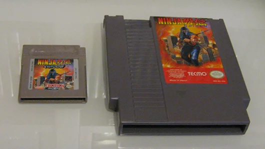 Game Boy cartridge next to a regular NES cartridge