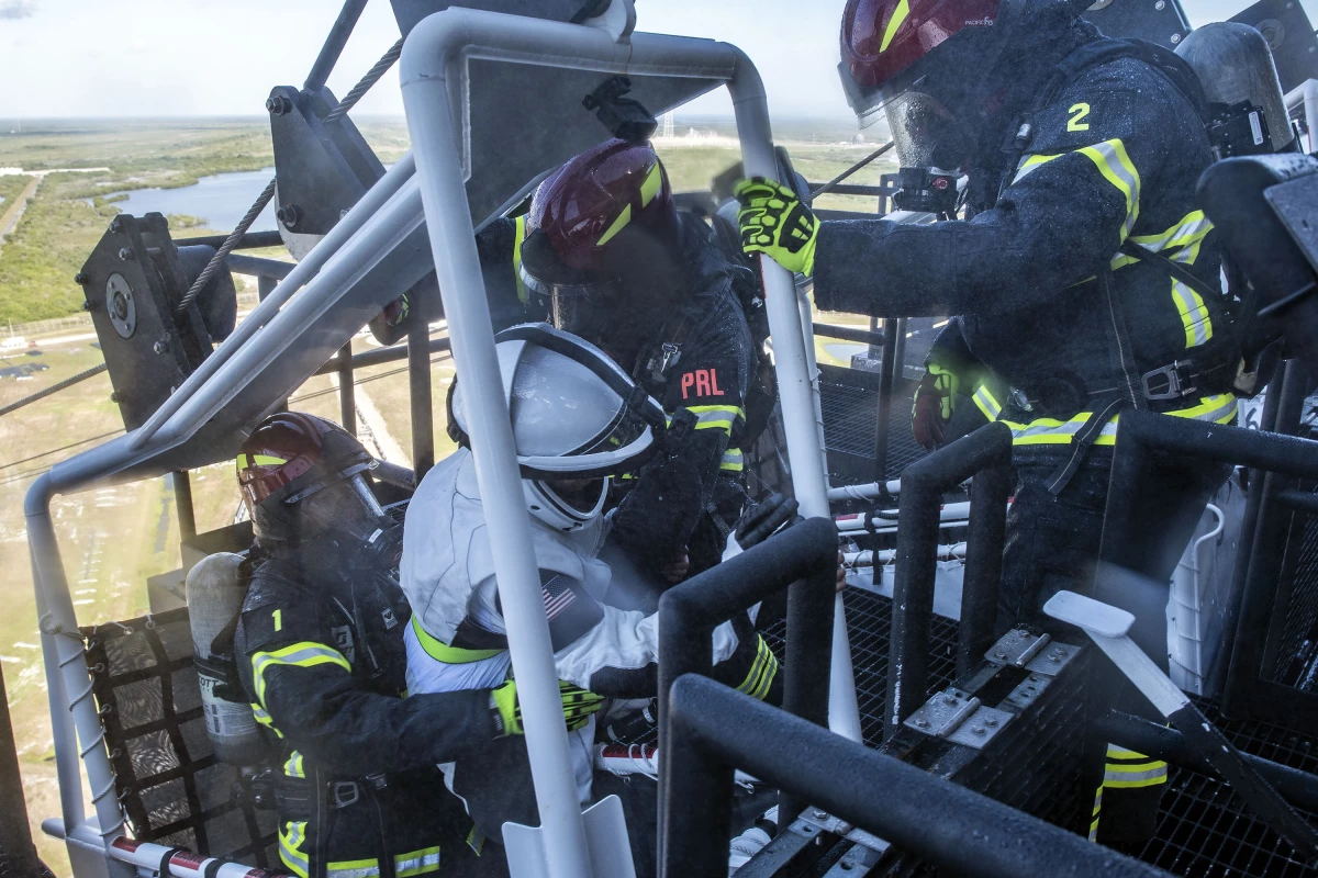 Teams loading "injured" personnel into the pad’s slidewire baskets for safely descending the tower