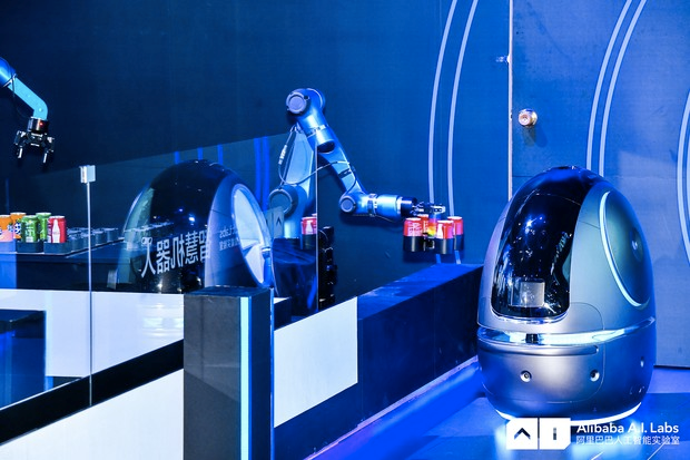 The robot will pick up requested items from either a human staff member or a robotic dispensing system