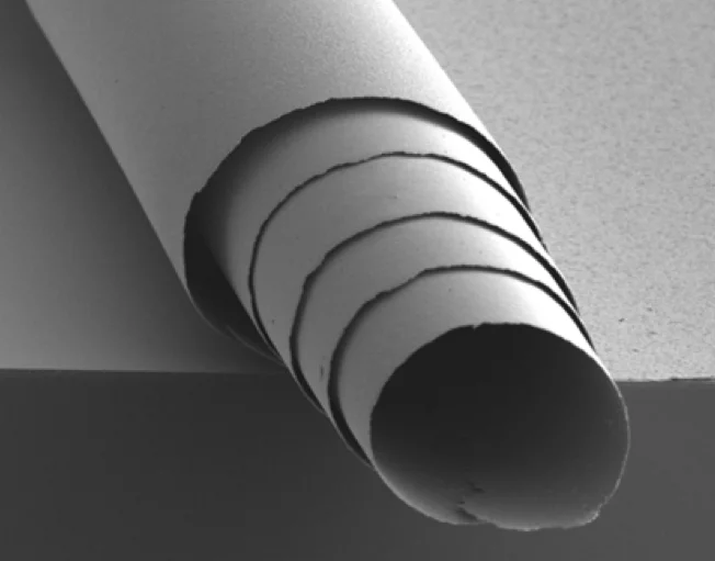 A rolled film of the material – the roll is about one tenth the diameter of a human hair