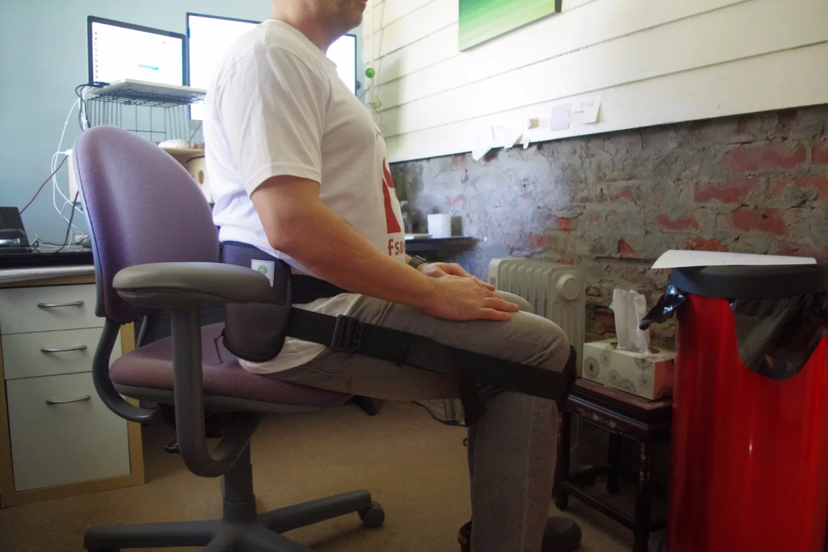 The author strapped into a Better Back harness at his desk