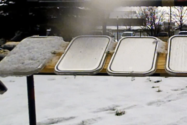 SLUGs coatings repel snow and ice on the right three panels, while it builds up on the far left untreated panel