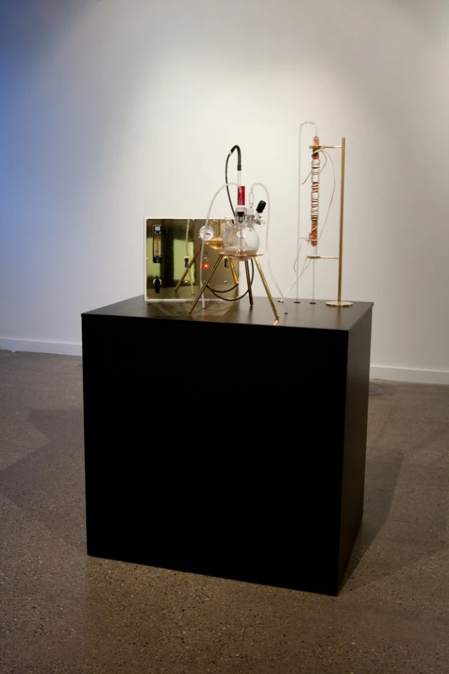 The Great Work of the Metal Lover is a portable laboratory featuring a highly specialized metallotolerant extremophilic bacterium called Cupriavidus metallidurans that's forced to metabolize huge amounts of gold chloride to form flecks of usable 24K gold (Photo: Adam Brown)