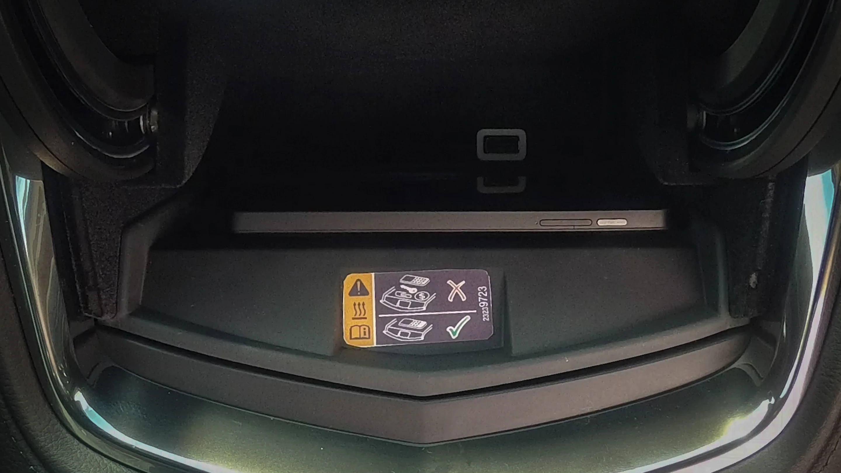 The rubberized Powermat wireless charging pad will positioned inside the storage bin behind car's center instrument panel