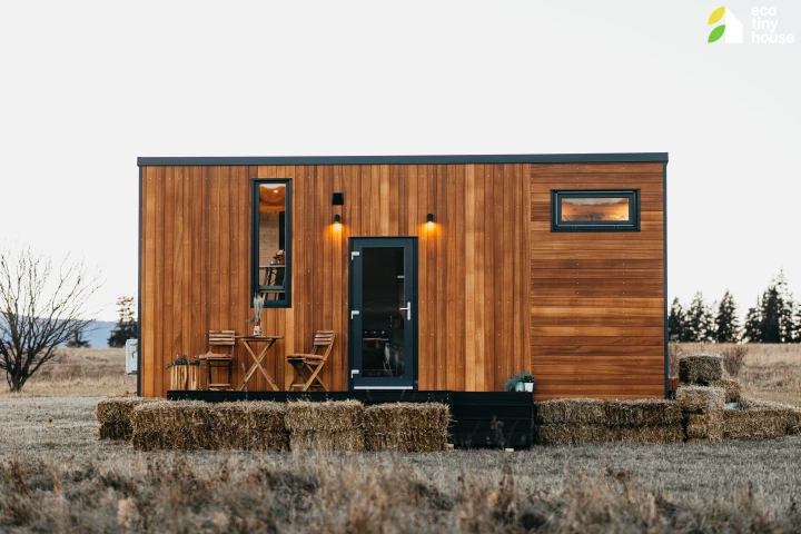 The Tiny Getaway is a compact tiny house that features an "upside-down" layout, situating the living room upstairs and a bedroom downstairs