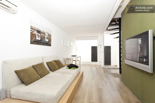 The home features designer furnishings, wooden floorboards and floor-to-ceiling windows