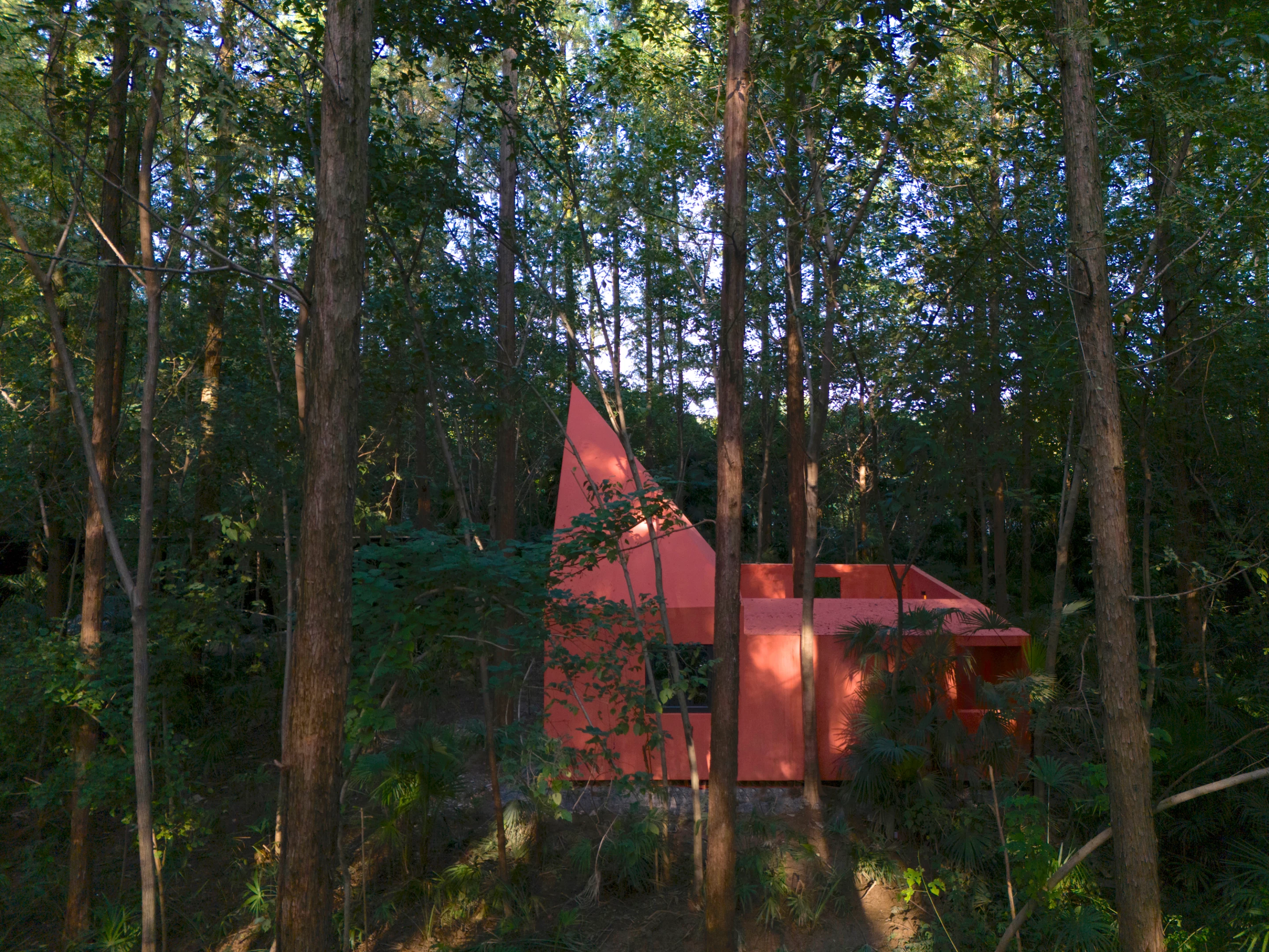 The natural forest floor remains untouched beneath the elevated structures