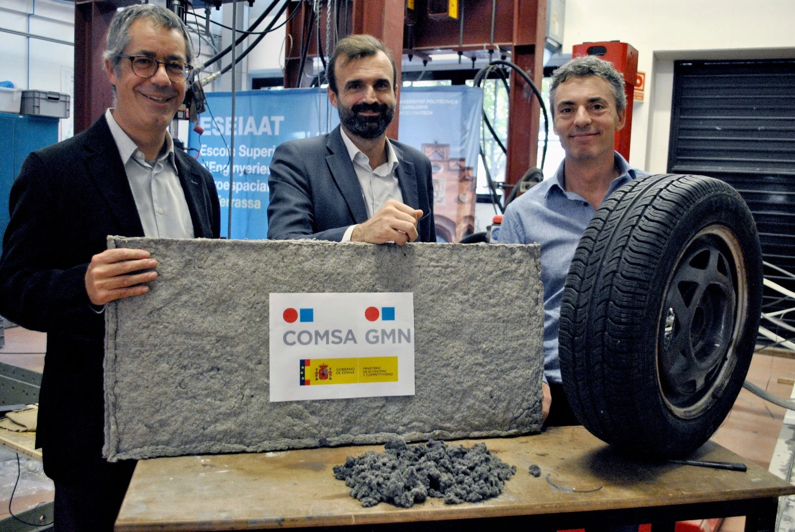 Researchers with a sheet of the tire fiber material