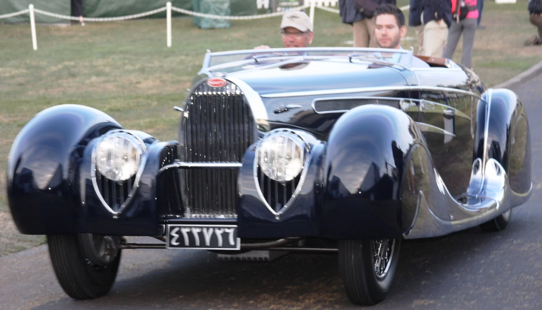A Bugatti slips by the Dawn patrol at Pebble Beach