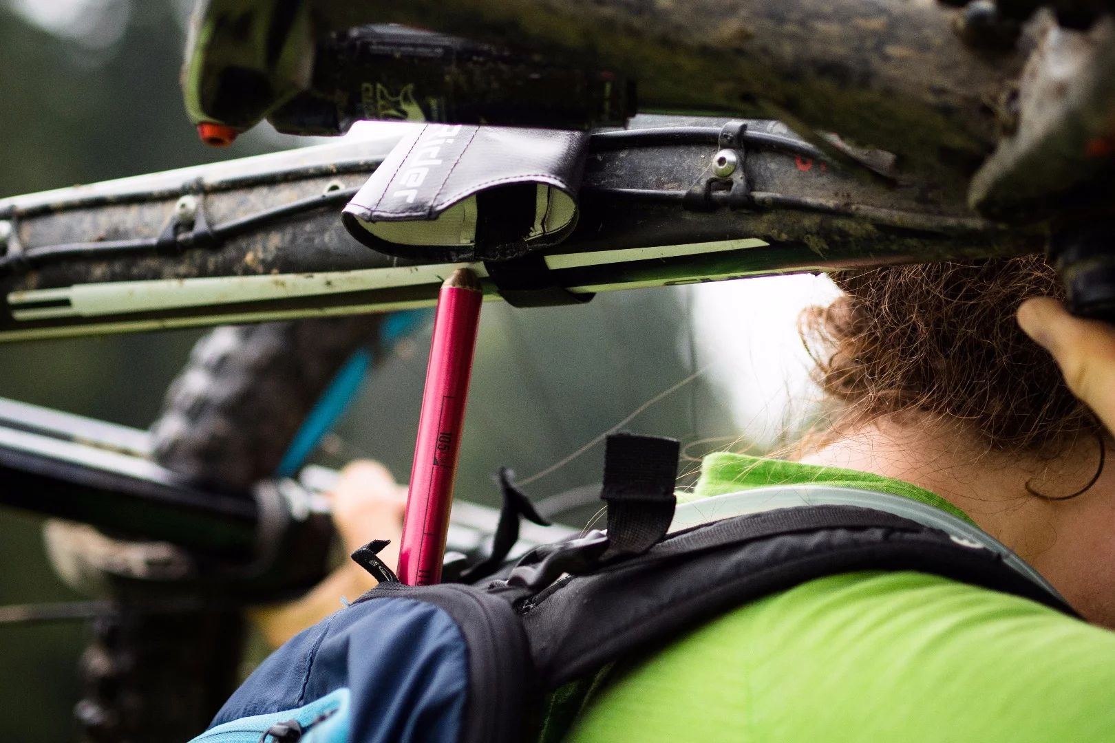 When it's time to carry the bike, the rider just hoists it up so that the pouch gets hooked over a knob on the top of the pole, which protrudes out of the pack