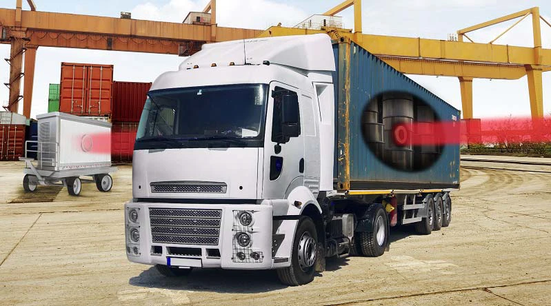 Artist rendering showing how the system detects nuclear materials hidden in a steel cargo container by using a pencil X-ray beam, emerging from the right, that penetrates through shielding and reveals an image of a hidden uranium object on a detector, at left