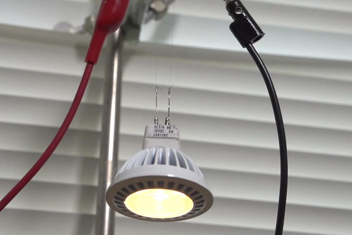 Two strands of the new CNT fiber support and supply current to an LED bulb