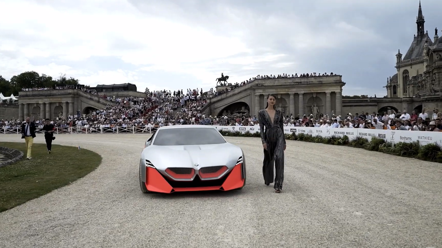 The BMW Vision M Next with accompanying model dressed by Talbot Ruehnof