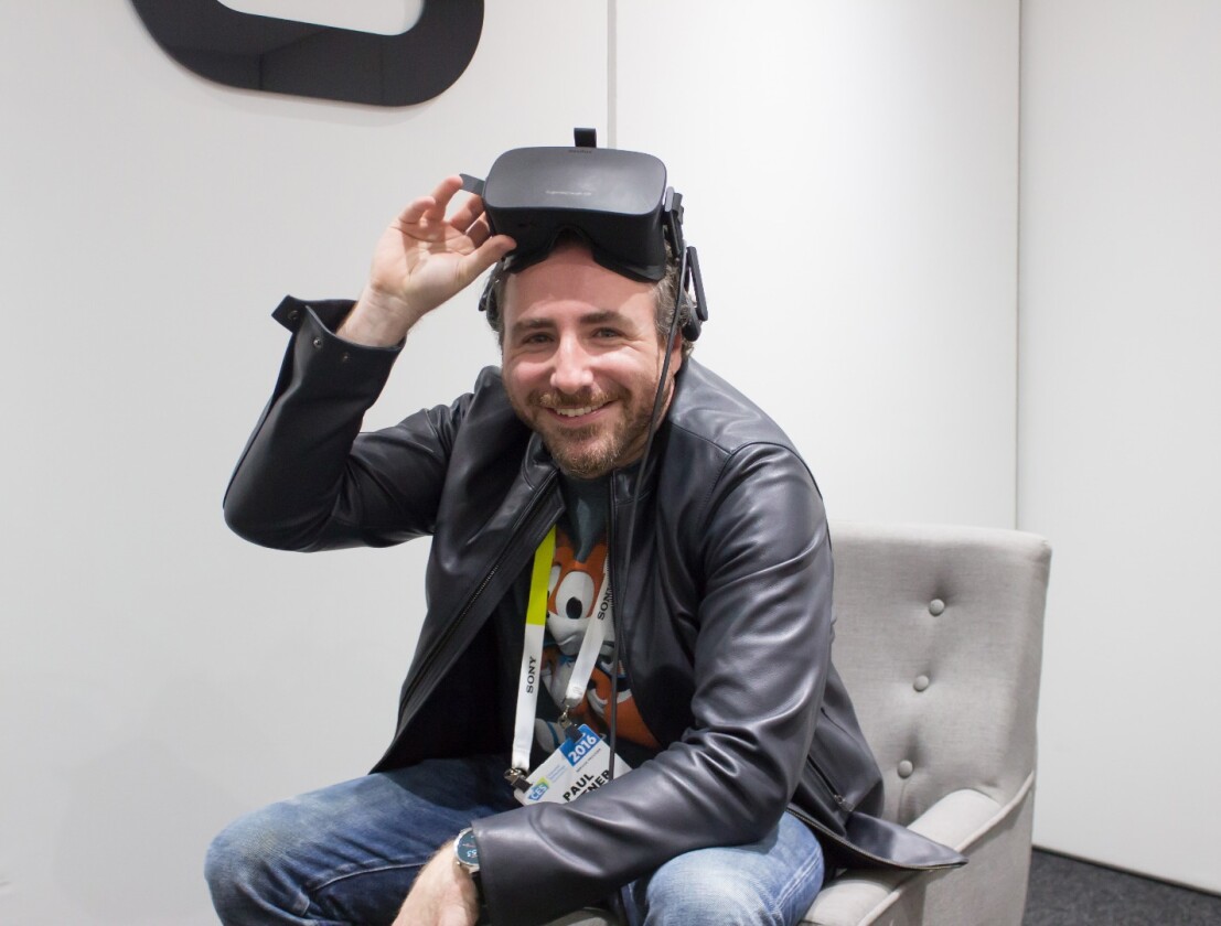 Paul Bettner wearing the Oculus Rift, which his game will ship with