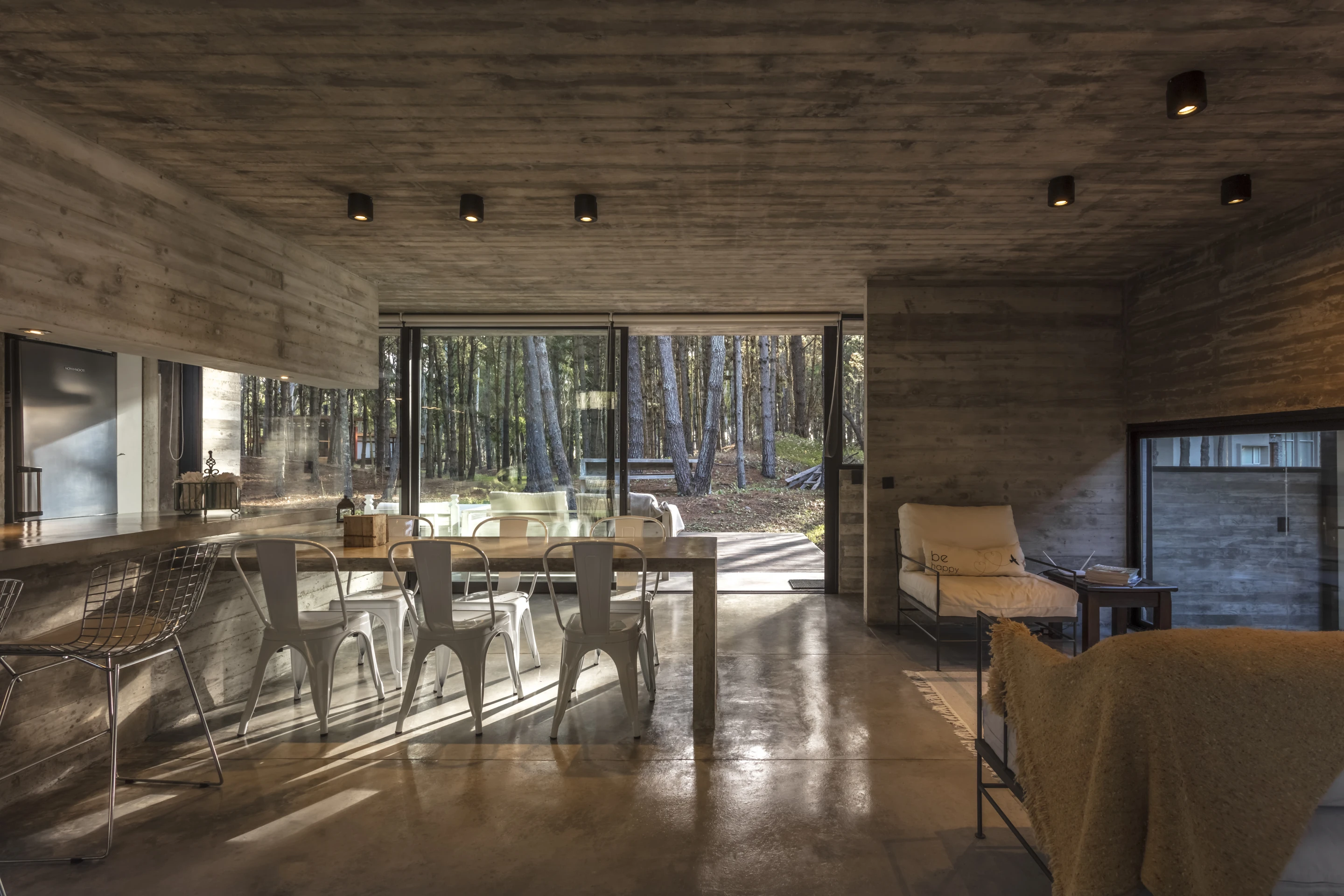 View of the open kitchen and dining area inside the Forest House, by Besonias Almeida