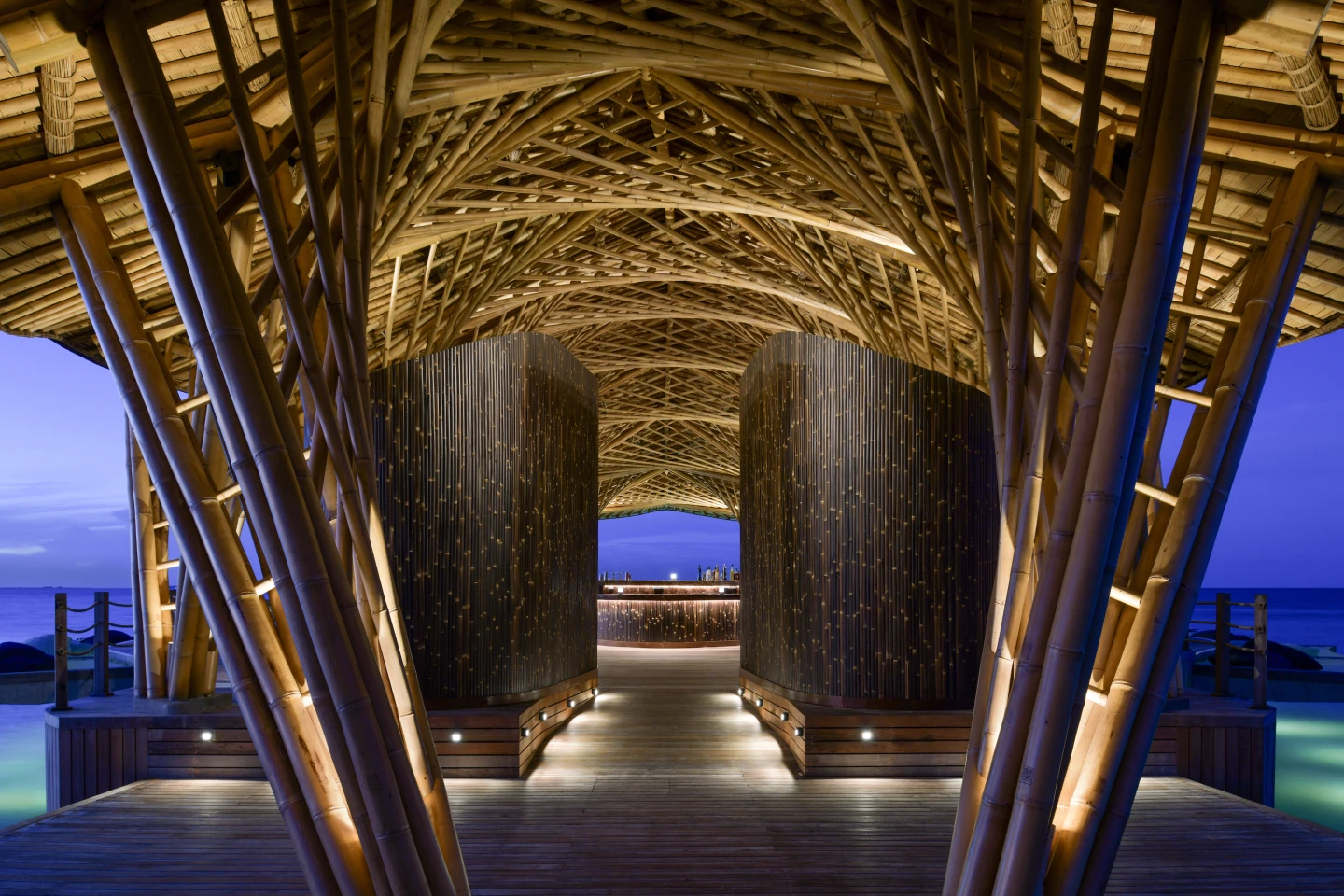 Intricate bamboo restaurant forms a sea creature on Maldives beach
