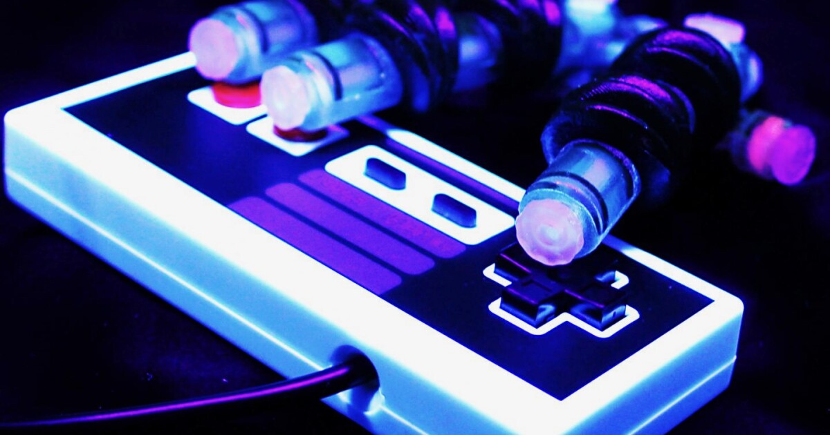 Air-powered tender robotic hand used to play Tremendous Mario Bros