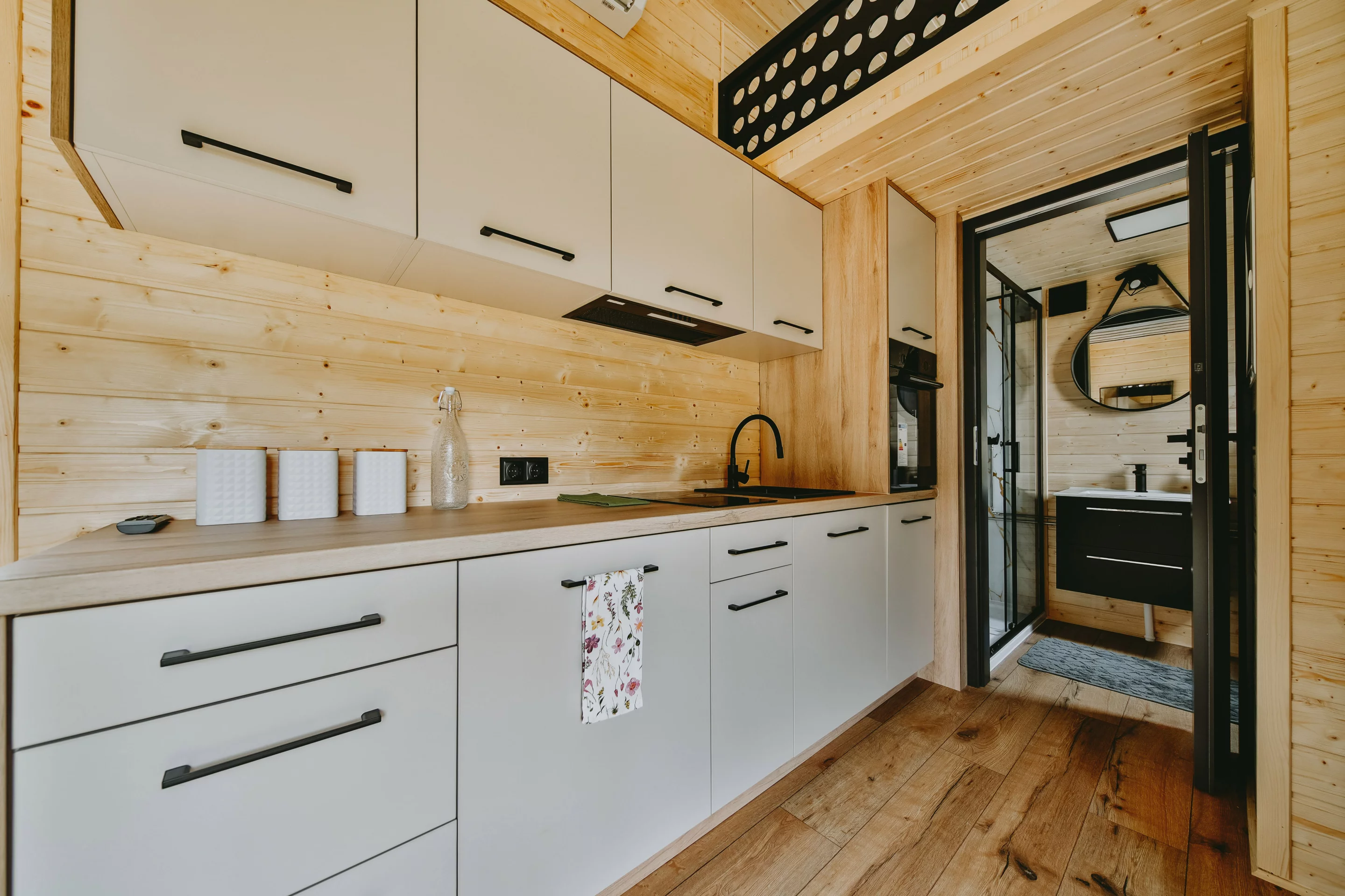 The Alan's kitchen includes an induction cooktop, an oven, a sink, and a fridge/freezer