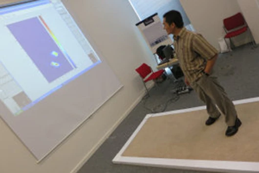The smart carpet uses embedded plastic optical fibers and electronics to detect a person's walking patterns