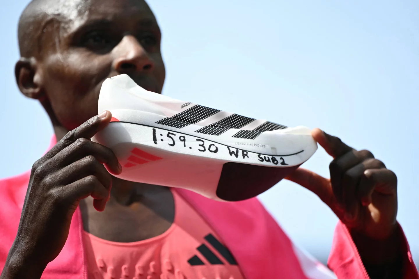 Sabastian Sawe poses with his new world record time written on his running shoe