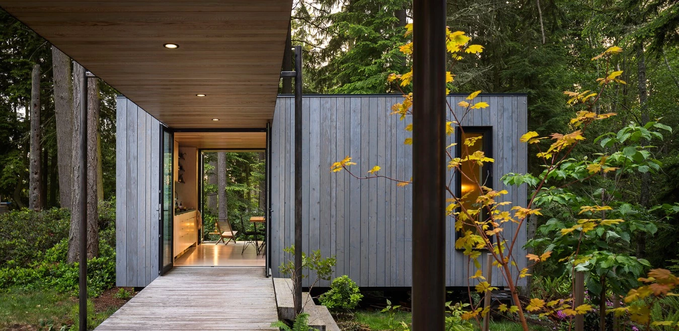 Expansive cedar decks of the Whidbey Puzzle Prefab bring indoor and outdoor spaces together
