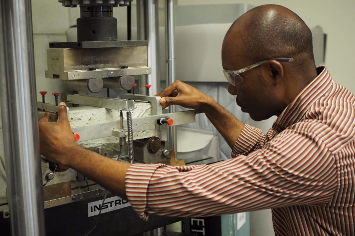 Civil engineering postdoctoral researcher Obinna Onuaguluchi tests the reinforced concrete