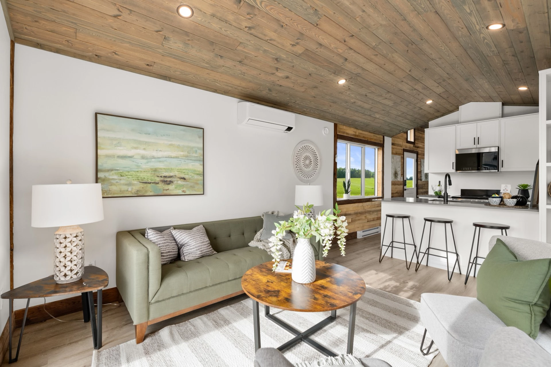 The Cypress' living room includes a sofa and seating, plus a couple of small tables