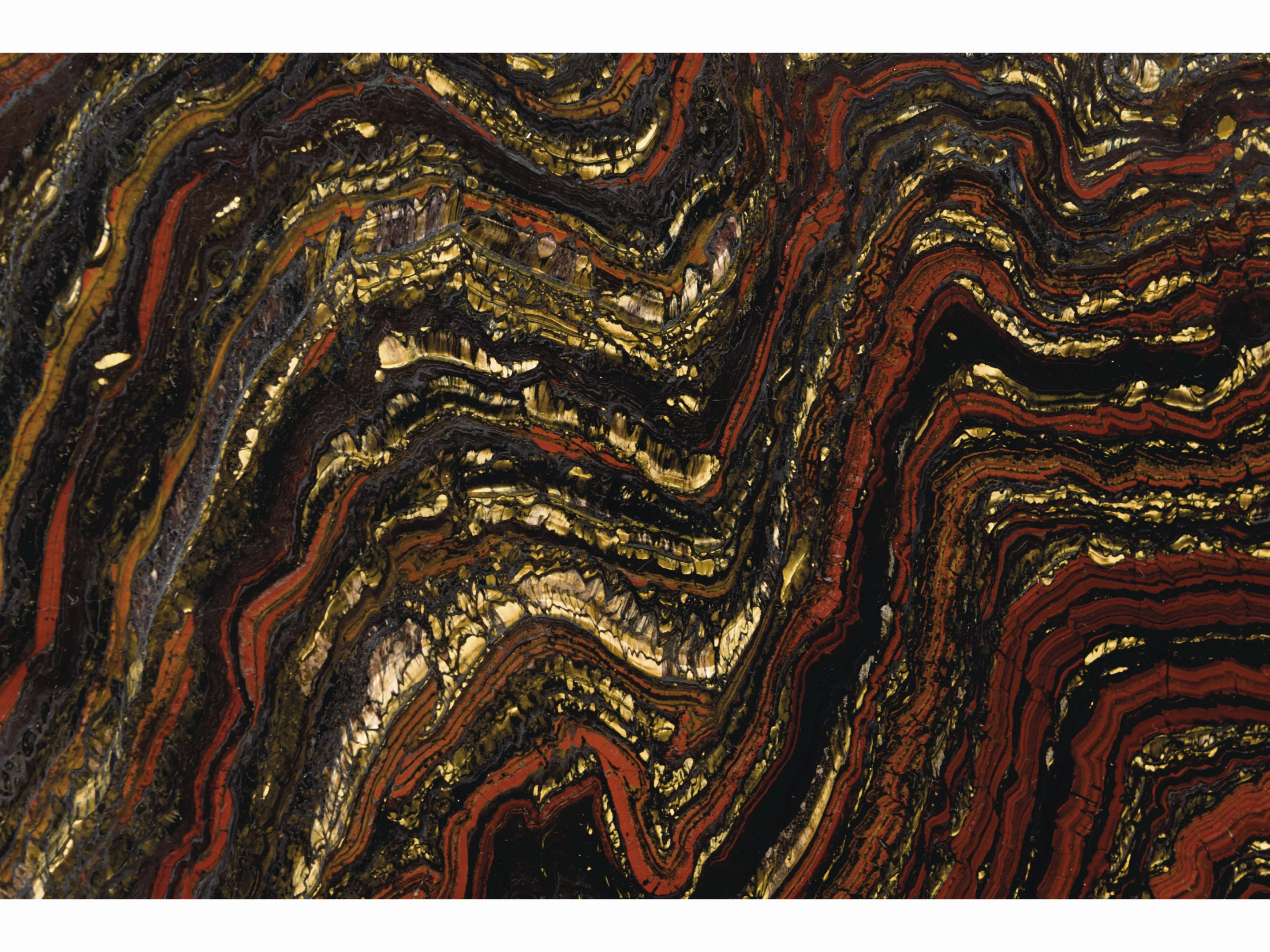 33-inch diameter "table top" 2.5cm thick specimen of banded layers of hematite, jasper and chatoyant Tiger-eye from the Paleoproterozoic (2.5 to 1.6 billion years ago) | Sold for: $12,997 (£10,000) by Christie's on October 28, 2020