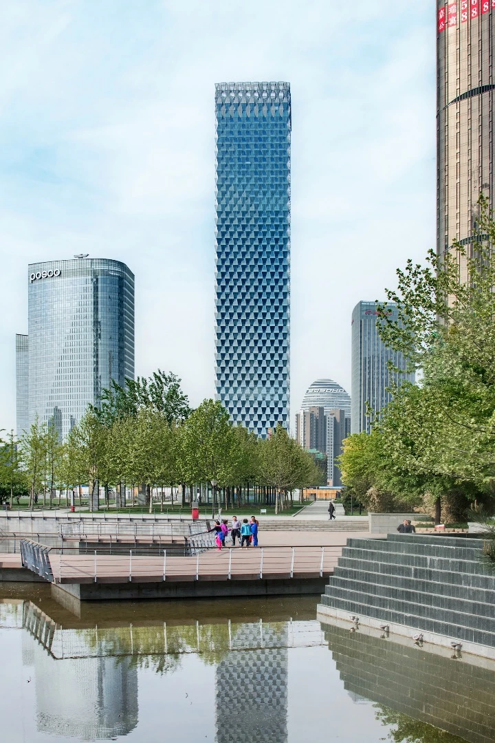 The Beijing Greenland Dawangjing Tower, by SOM, features a trapezoid-clad exterior with glass panels