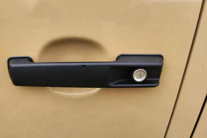 The nostalgic thumb-push handle on a current-generation Mercedes-Benz