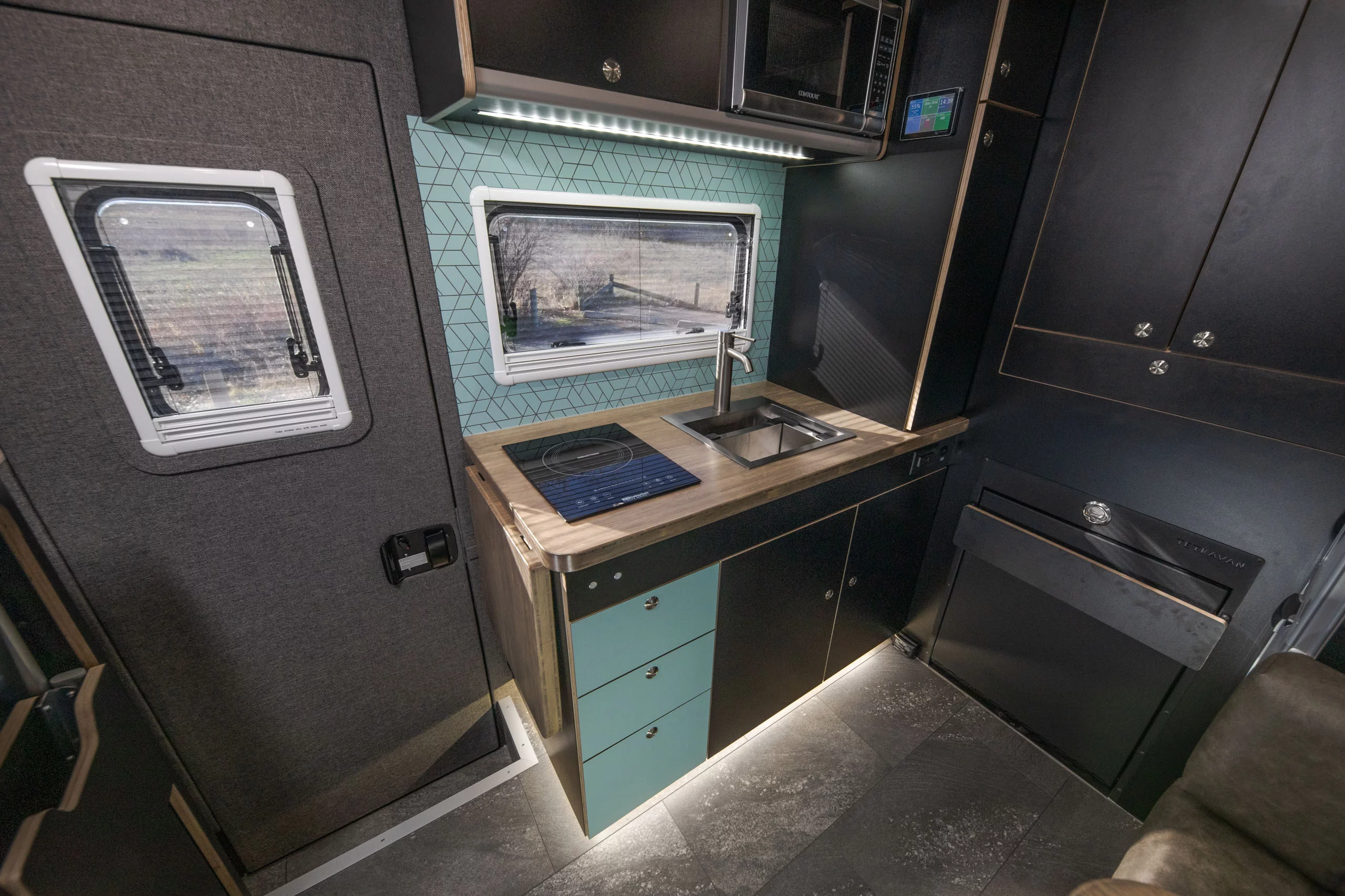 The Grid Mini includes an induction cooktop, large fridge/freezer and microwave powered by the off-grid electrical system